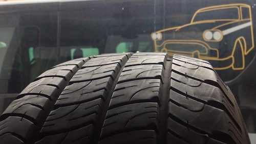 Close-up of an all-weather tyre, with fewer grooves than a snow tyre